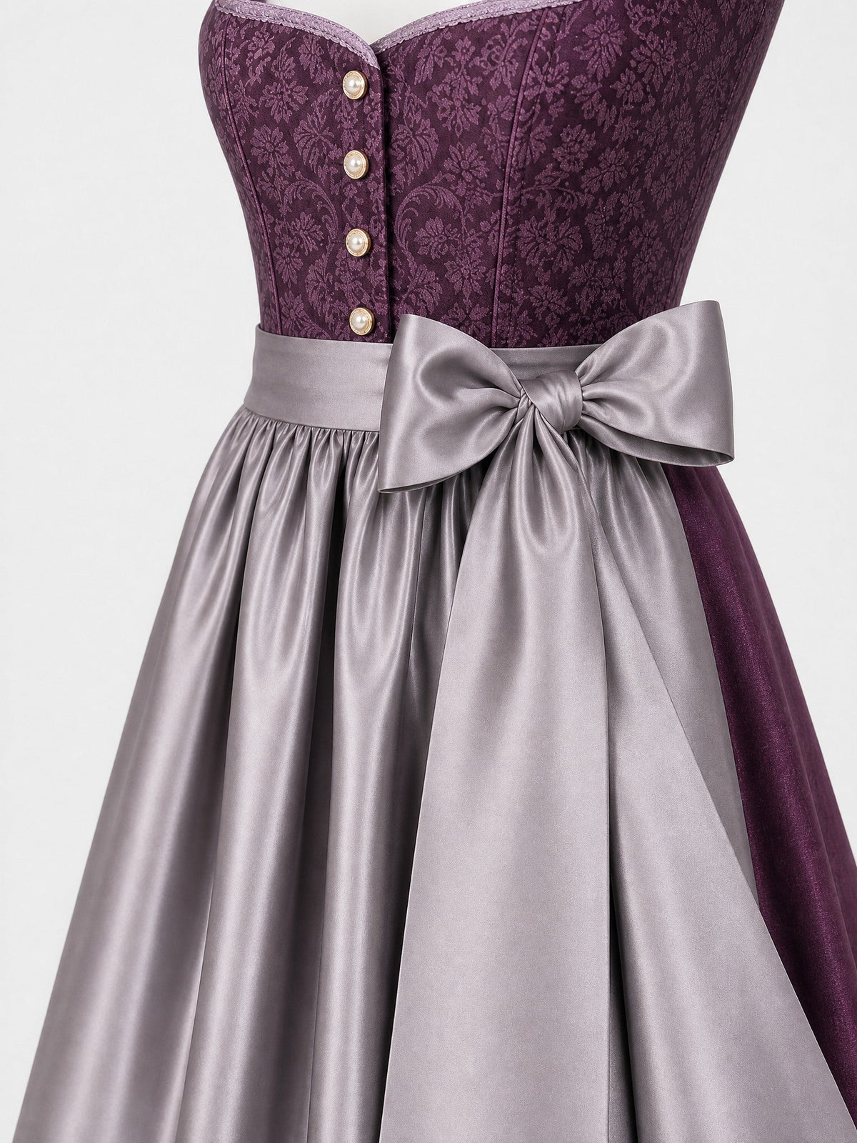 Dirndl Amelia in Aubergine mit Perlgrau Schürze - Detailansicht Taille und Schleife